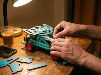 Building the kit at a desk in the evening, chai and phone set aside